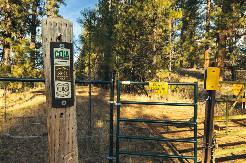 Gate with "Please close gate" sign on Ponderosa Loop trail